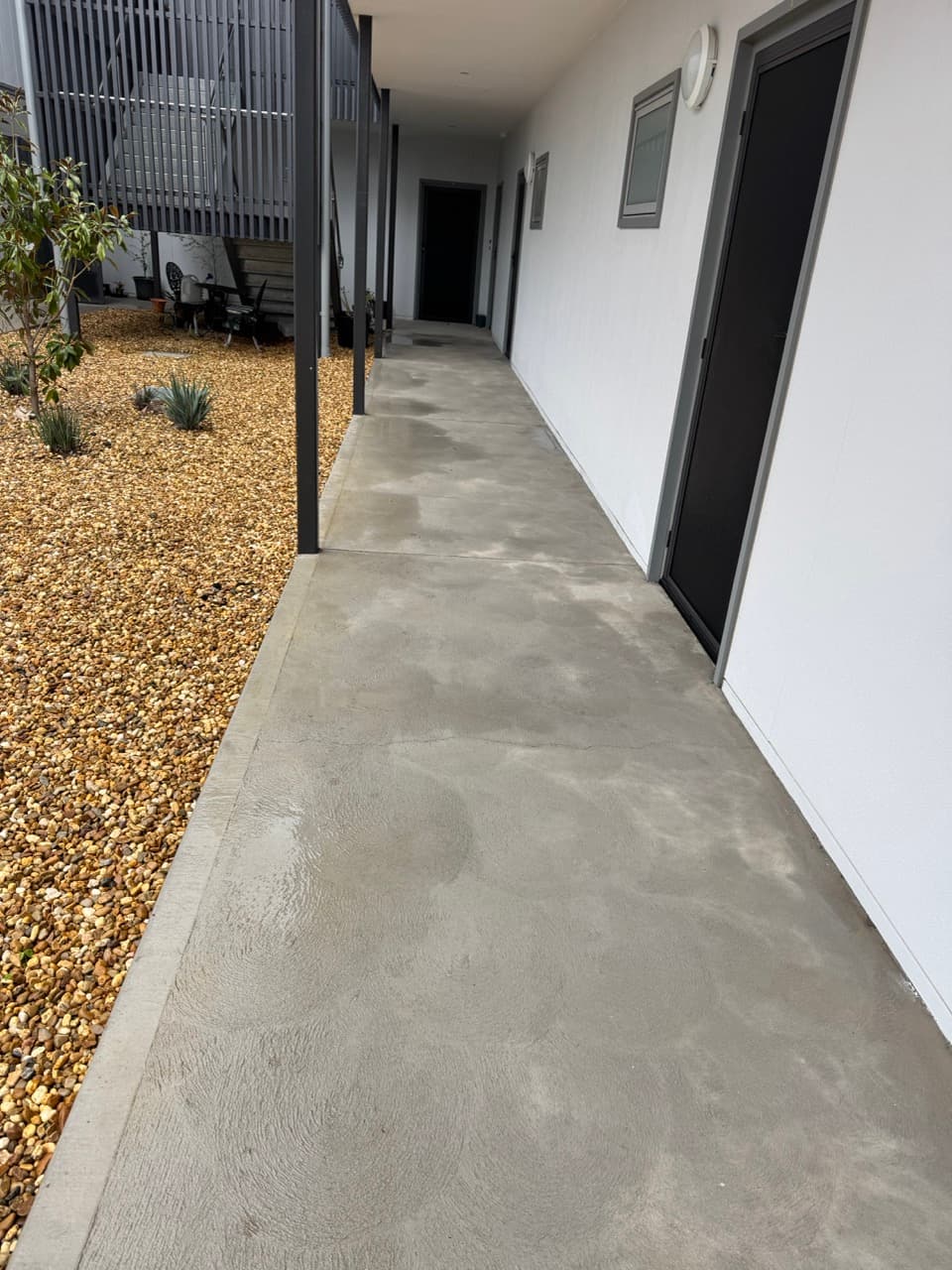 Pressure washing a driveway or paved surface by Laser Cut Mowing